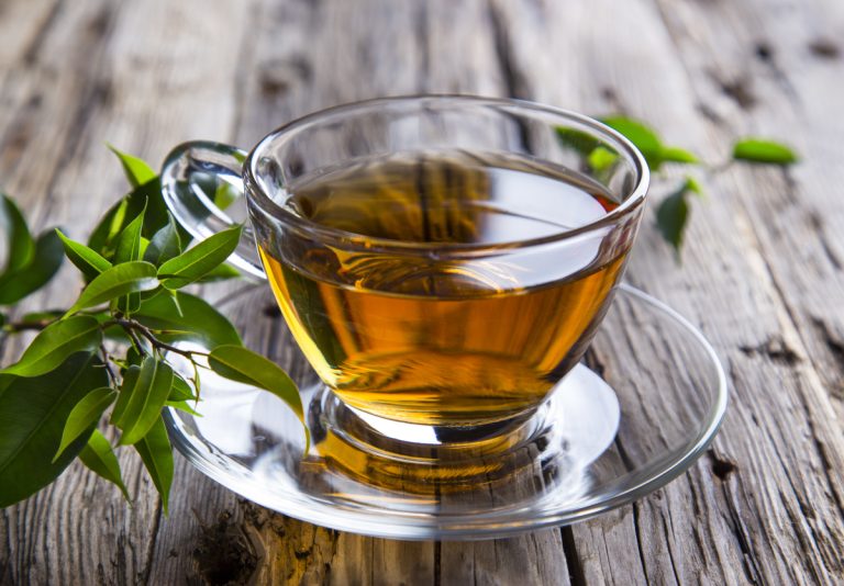 transparent cup of green tea