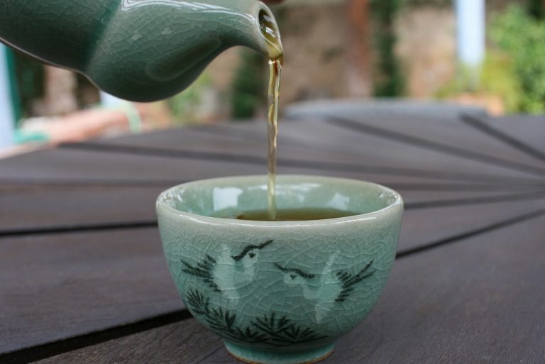pouring tea into a teacup