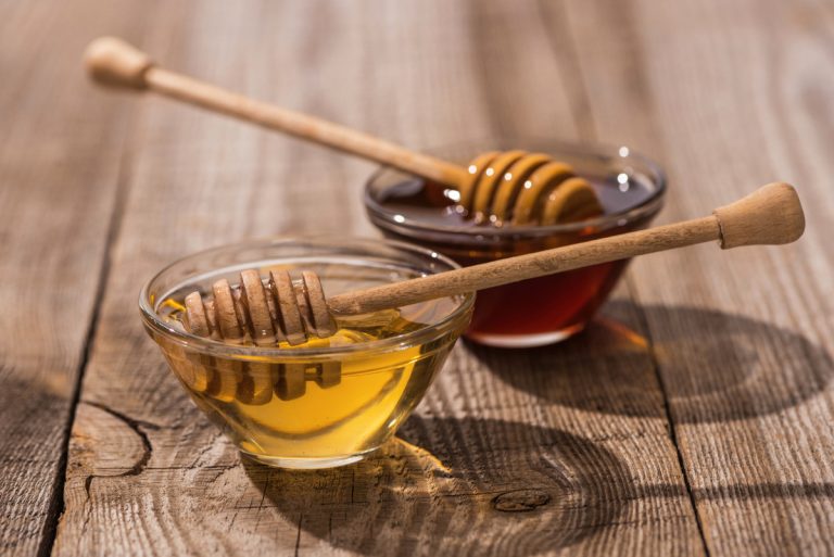 Jars with honey and honey dippers