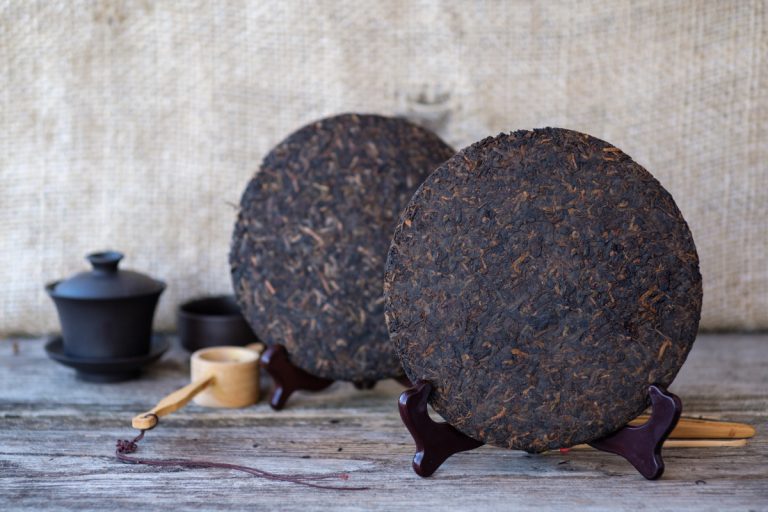 small chinese puer tea cakes on stands