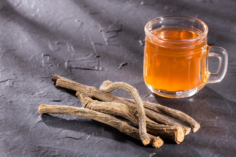 Valerian herb sprigs with a cup of herbal tea