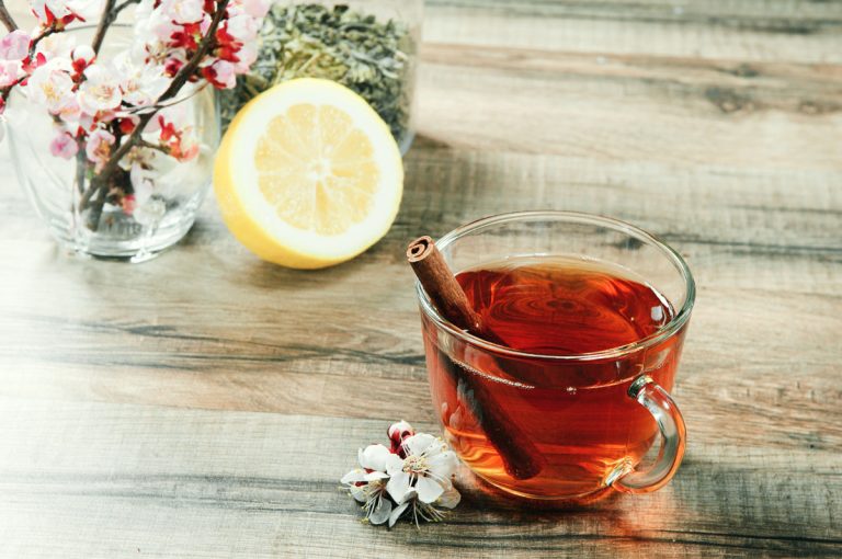 cup of black tea with cinnamon stick