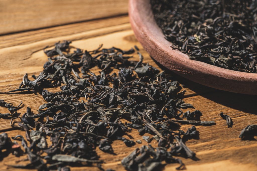 Dried Black Tea on Wooden Table