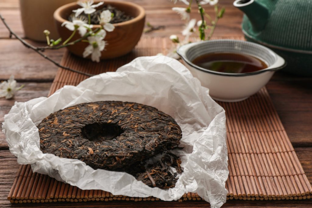 disc shaped puer tea on wooden table
