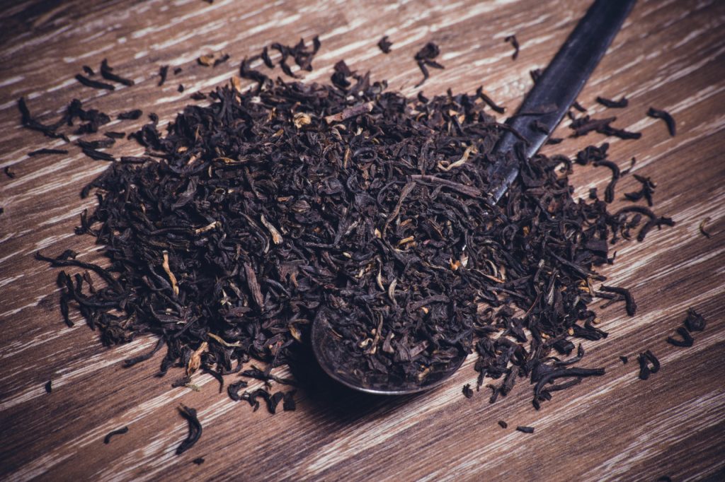 dried black tea on a metal spoon