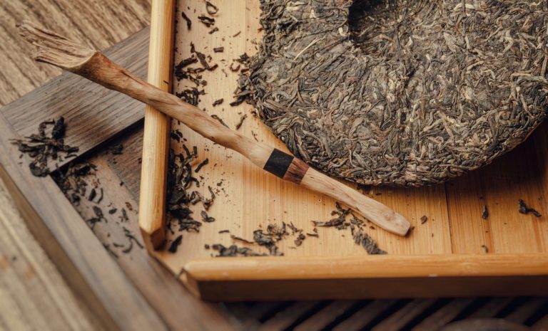 sheng puer tea on wooden tray