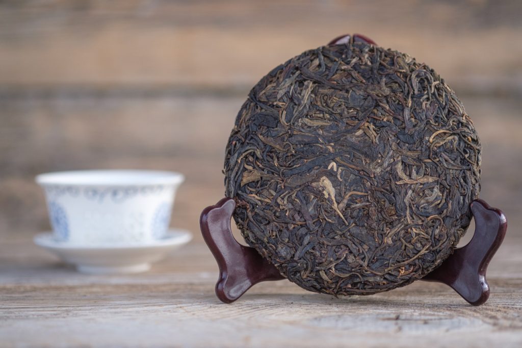 traditional Chinese pu-erh tea on a wooden stand