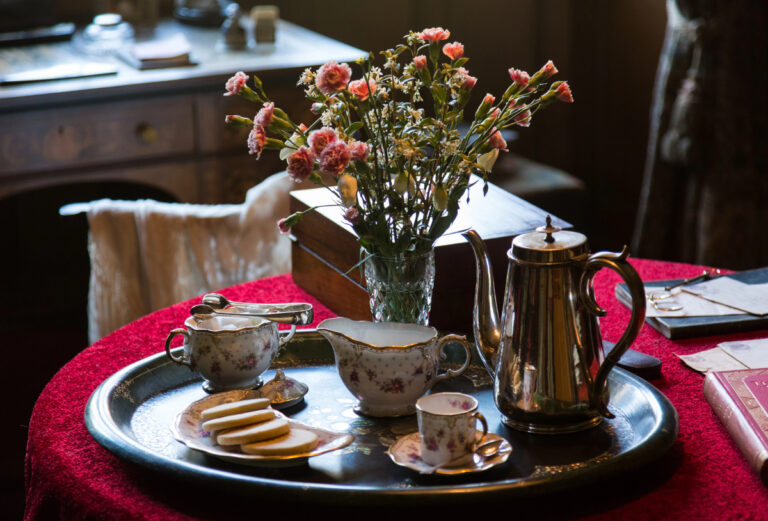 antique china tea set on silver tray in a tea room