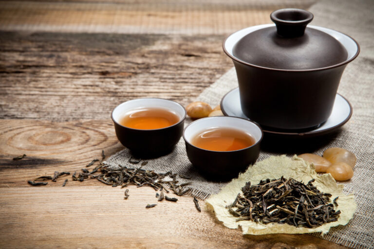 gaiwan and teacups on a cloth