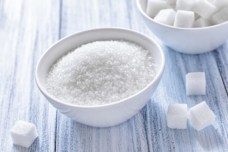 white sugar on a blue wooden background